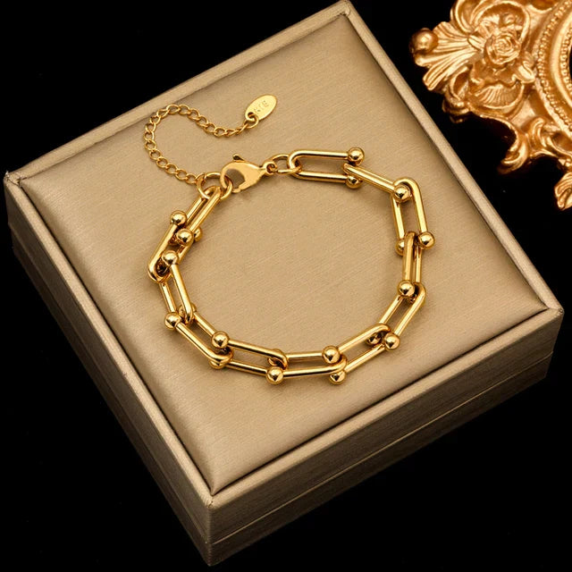Image of the Celestial Charm Bracelet – an 18K gold stainless steel bracelet with star and moon charms, perfect for cosmic-inspired elegance.