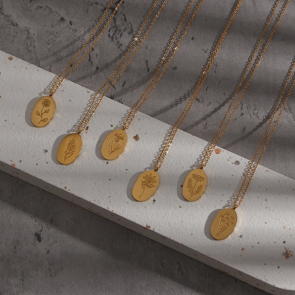 Fleur Oval Coin Necklace featuring a vintage-inspired oval pendant with elegant details.