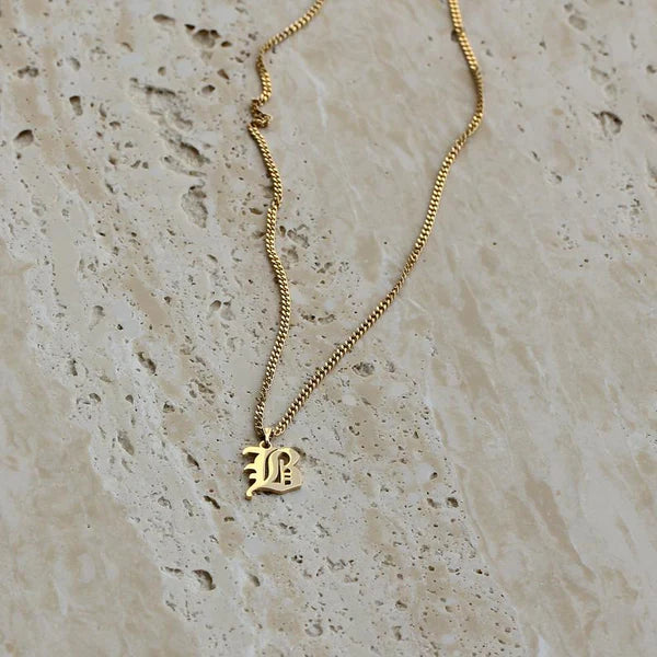 Camille Vintage English Letter Necklace featuring a bold old English initial pendant.

