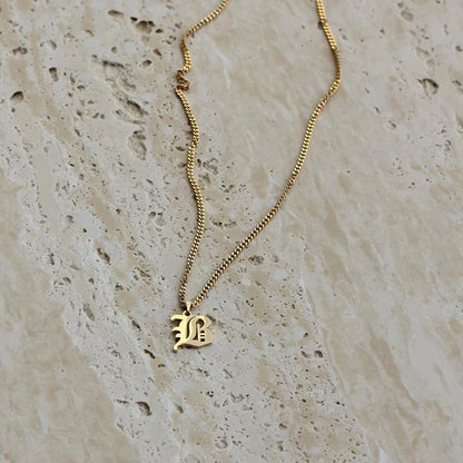 Camille Vintage English Letter Necklace featuring a bold old English initial pendant.

