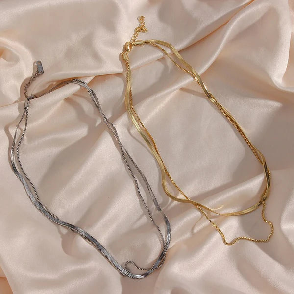 Cleo Herringbone Necklace featuring a smooth, shiny chain with timeless elegance.

