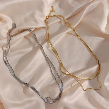 Cleo Herringbone Necklace featuring a smooth, shiny chain with timeless elegance.

