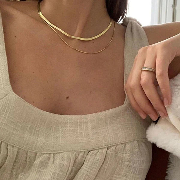 Cleo Herringbone Necklace featuring a smooth, shiny chain with timeless elegance.

