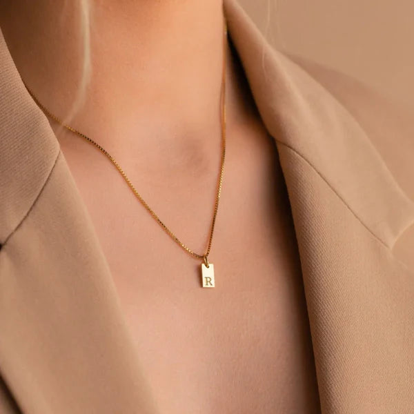 Dainty Tag Necklace featuring a slim, minimalist tag pendant on a delicate chain.

