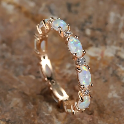 Image of the Eternity Opal Band Ring – a radiant ring with shimmering opals in a continuous band, symbolizing elegance and eternity.

