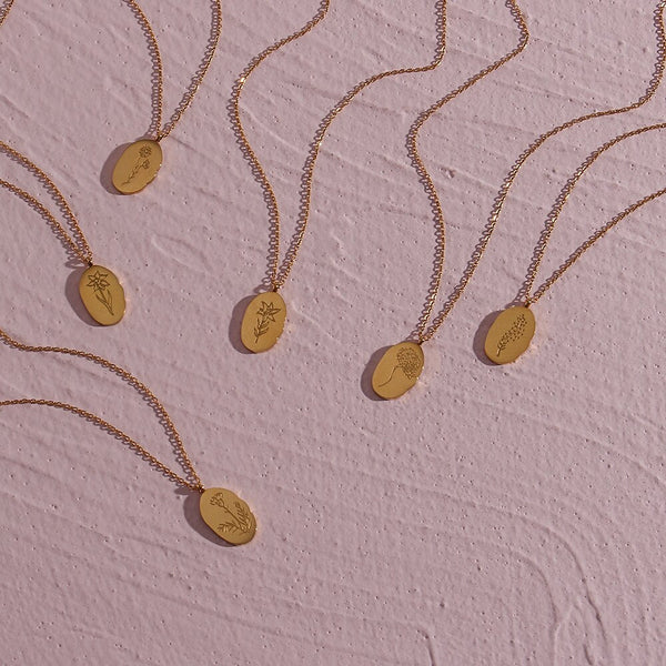 Fleur Oval Coin Necklace featuring a vintage-inspired oval pendant with elegant details.

