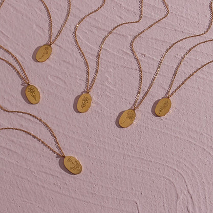 Fleur Oval Coin Necklace featuring a vintage-inspired oval pendant with elegant details.

