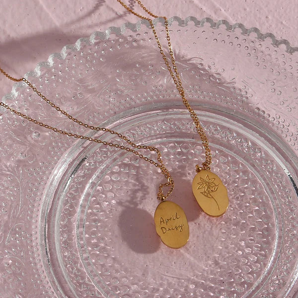 Fleur Oval Coin Necklace featuring a vintage-inspired oval pendant with elegant details.

