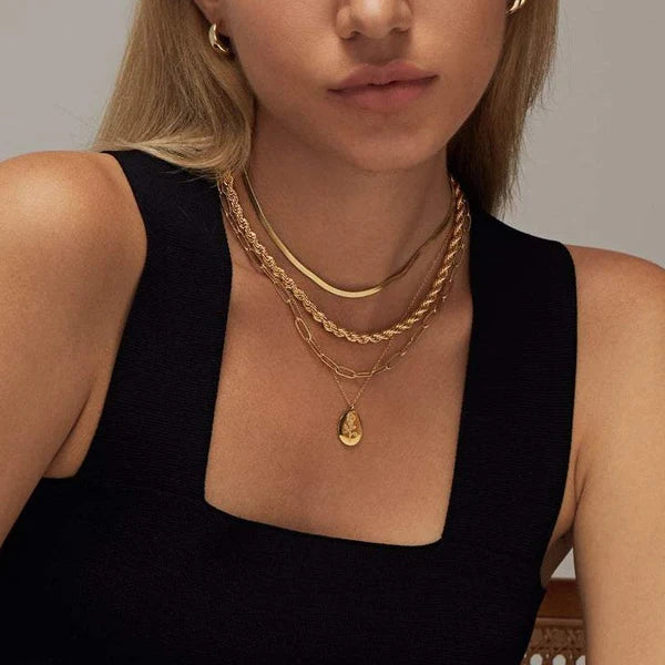 Fleur Oval Coin Necklace featuring a vintage-inspired oval pendant with elegant details.

