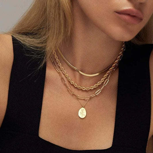 Fleur Oval Coin Necklace featuring a vintage-inspired oval pendant with elegant details.

