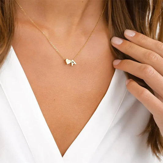 Heart Initial Necklace featuring a delicate heart-shaped charm with custom letter engraving.

