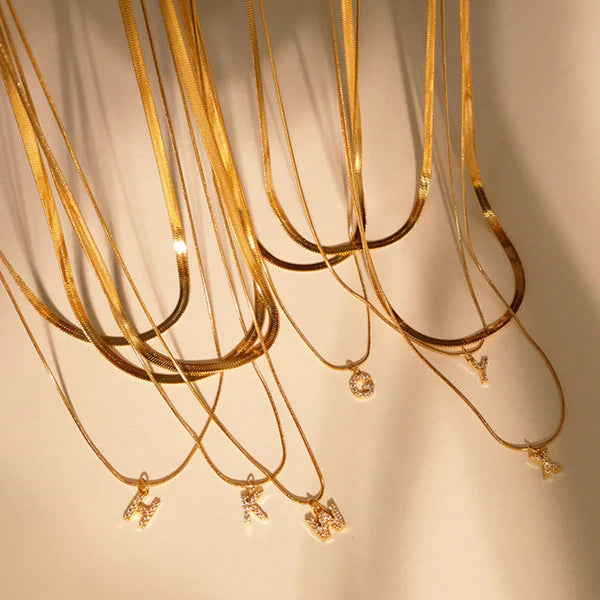 Herringbone Initial Necklace with a stylish chain and personalized initial pendant.

