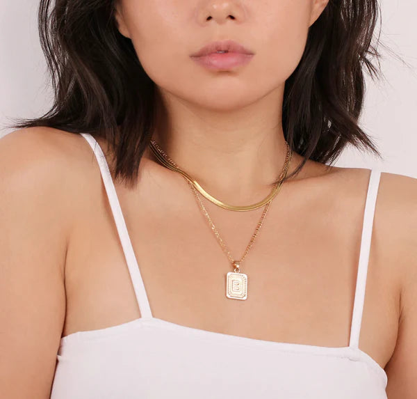 Leila Square Letter Pendant Necklace with a minimalist design and engraved initial.

