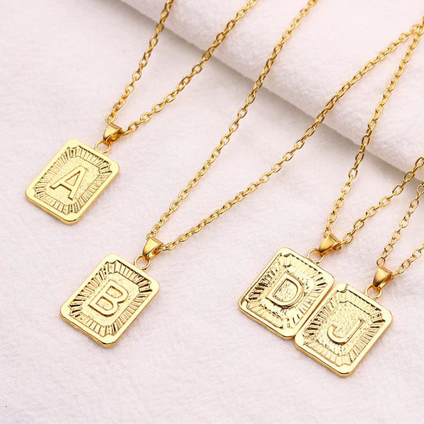 Leila Square Letter Pendant Necklace with a minimalist design and engraved initial.

